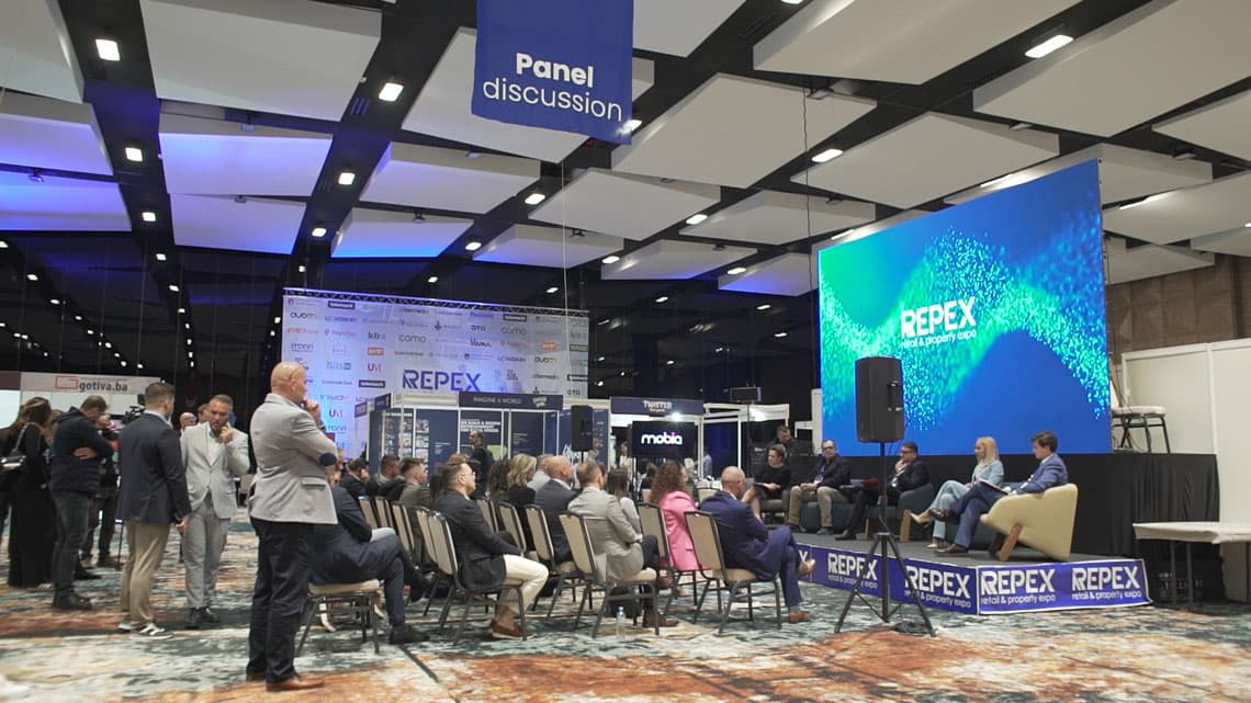 A Repex conference panel discussion in a full hall